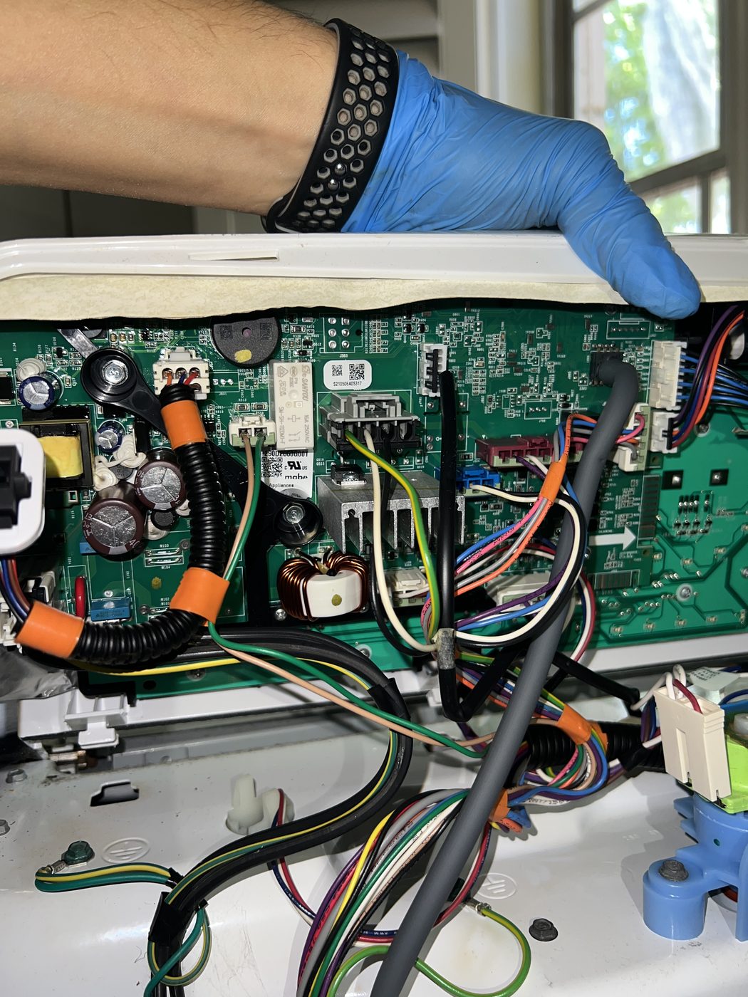 Close-up of an appliance control board during a diagnostic repair