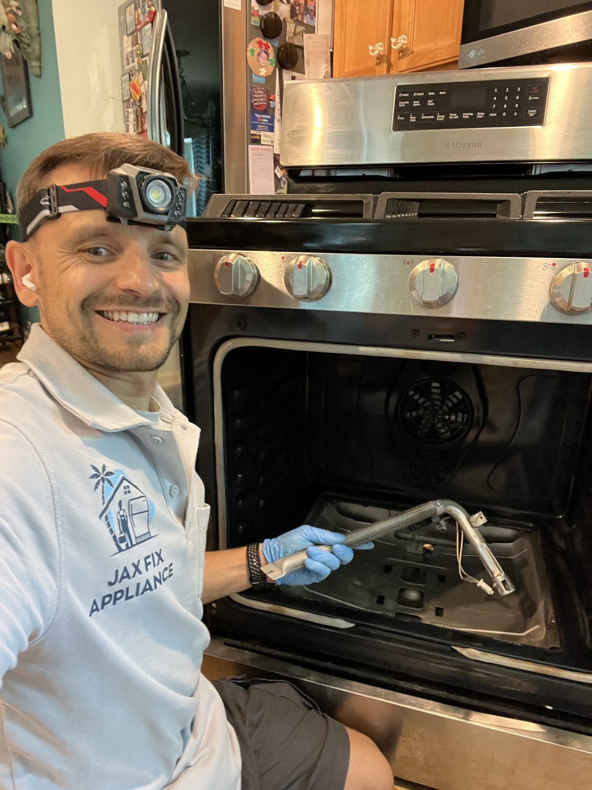 Konstantin servicing the burner assembly inside a gas range oven